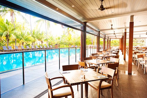 Open air dining terrace looking out over the resort pool